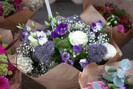 Bouquet of roses, gypsophila and lisianthus in craft paper for weddingの写真素材