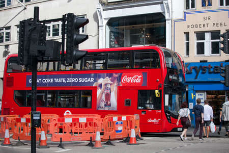 LONDON, ENGLAND - August 20, 2017 red double-decker bus stops at a traffic light near Liverpool streetのeditorial素材