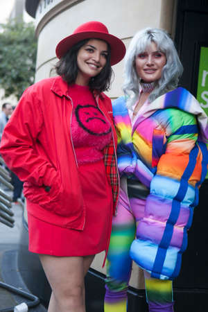 LONDON, ENGLAND - September 15, 2017 Beautiful and stylish woman in red coan and skirt posing during the London Fashion Week. outside Eudon Choiのeditorial素材