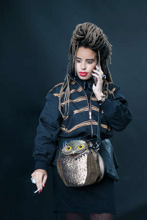 LONDON, ENGLAND - September 15, 2017 A woman with dreadlocks, a tattoo in front of her eyes, in a...