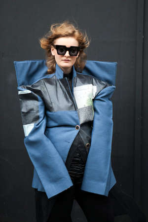LONDON, ENGLAND - September 15, 2017 Beautiful and stylish woman in blue coat posing during the...
