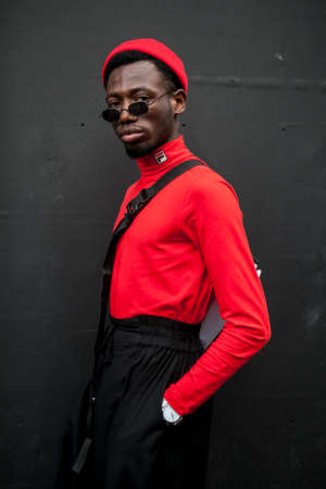 LONDON, ENGLAND - September 15, 2017 Beautiful and stylish man in red shirt, hat and jeans posing during the London Fashion Week. outside Eudon Choiのeditorial素材