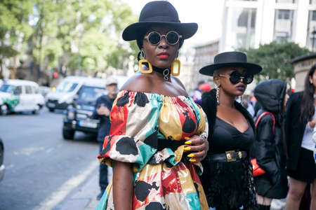 LONDON, ENGLAND - September 15, 2017 Beautiful and stylish woman in colrful yellow nice dress posing during the London Fashion Week. outside Eudon Choiのeditorial素材