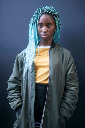LONDON, ENGLAND - September 15, 2017 Beautiful and stylish woman in green coat and yellow t-shirt posing during the London Fashion Week.のeditorial素材