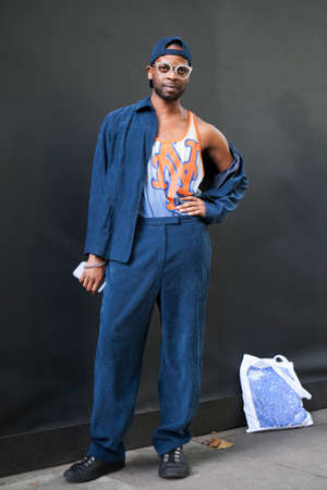 LONDON, ENGLAND - September 15, 2017 Beautiful and stylish A man in a cap, glasses and blue suit posing during the London Fashion Week. outside Eudon Choiのeditorial素材