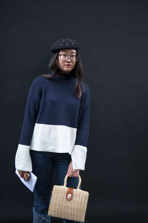 LONDON, ENGLAND - September 15, 2017 Beautiful and stylish Woman in black and white knitted sweater and black beret posing during the London Fashion Week. outside Eudon Choiのeditorial素材