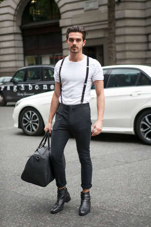 LONDON, ENGLAND - September 15, 2017 Beautiful and stylish man in white t-shirt and black jeans posing during the London Fashion Week. outside Eudon Choiのeditorial素材