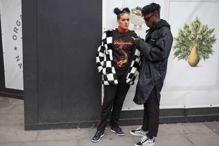 LONDON, ENGLAND - September 15, 2017 Beautiful and stylish woman inblack and white coat posing during the London Fashion Week. outside Eudon Choiのeditorial素材