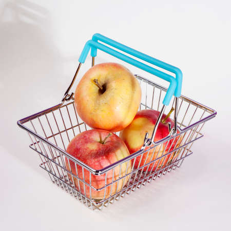 the Shopping basket with apple isolated on white backgroundの写真素材