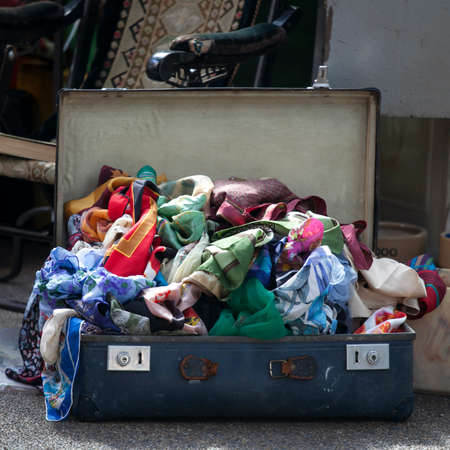 LONDON, ENGLAND - September 11, 2017 Antique market in the Spitalfields market is traditionally held on Thursdays. A suitcase with silk kerchiefs stands on the groundのeditorial素材