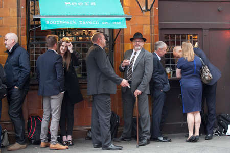 LONDON, ENGLAND - September 11, 2017 A mixed-race crowd in a pub drinking beerのeditorial素材