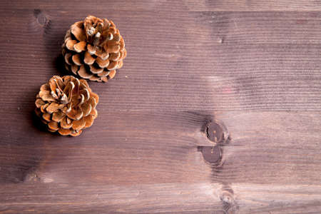 Cone over a Natural Dark Wooden background. Old dirty wood tables or parquet with knots and holes and aged partculars.の写真素材