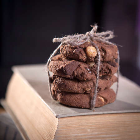 dark chocolate biscuits with nuts on dark wooden background