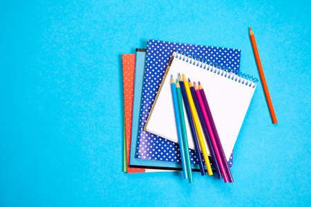 Assorted school supplie with a notebooks on blue backgroundの写真素材