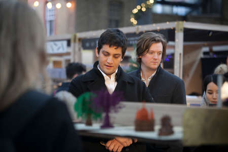 London, UK - December 22, 2017: People buy food in street cafes at a business lunch on the Spitalfields marketのeditorial素材