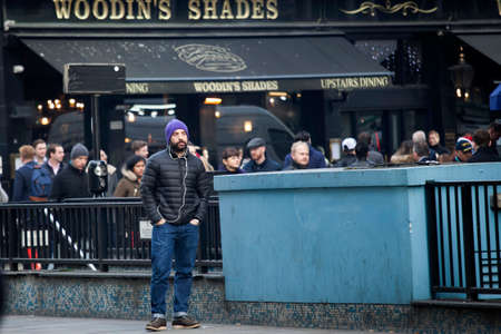 London, UK - December 22, 2017: A man in jeans stands near the road against the background of an old...