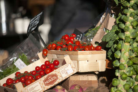 LONDON, ENGLAND - December 18 , 2017 Tomatoes and Brussels sprouts in wooden boxes on the Borough marketのeditorial素材