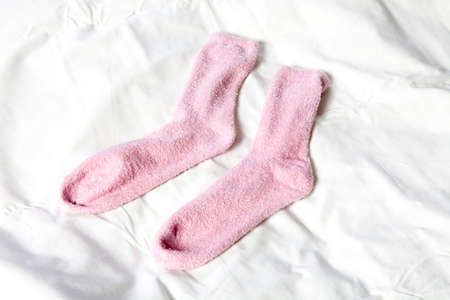 pink socks on the white blanket