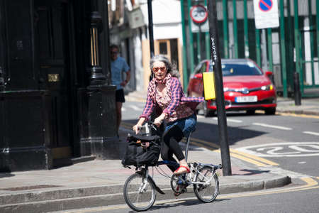 LONDON, ENGLAND - December 18 , 2017 Senior woman riding bicycleのeditorial素材