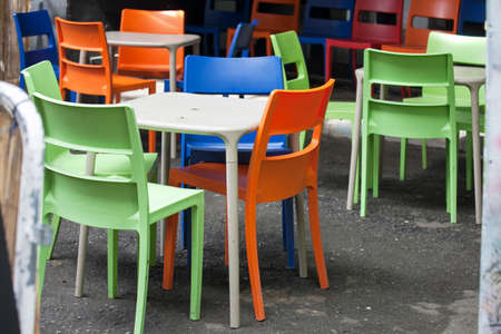 Multicolored plastic furniture on the street near the cafeの写真素材