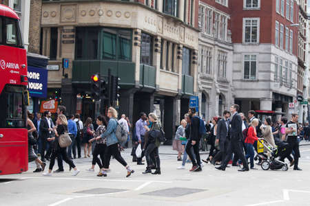LONDON, ENGLAND - AUGUST 22, 2017 People cross the road near Liverpool Street subway.のeditorial素材