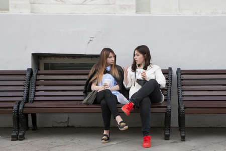 Moscow, Russia - 21 June 2017 Girls with long hair sit on a park bench and have conversationのeditorial素材