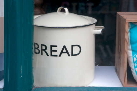 An old saucepan with the inscription Bread in the window of an antique store.の写真素材
