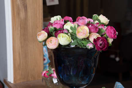 pink ranunculus persian buttercup in glasses on the wood table