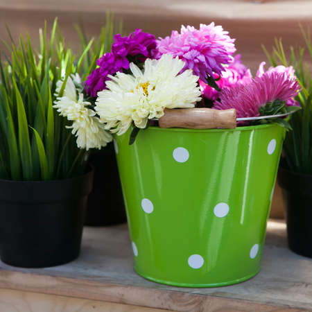 beautiful bouquet of bright wildflowers in green with spot metal bucketの写真素材