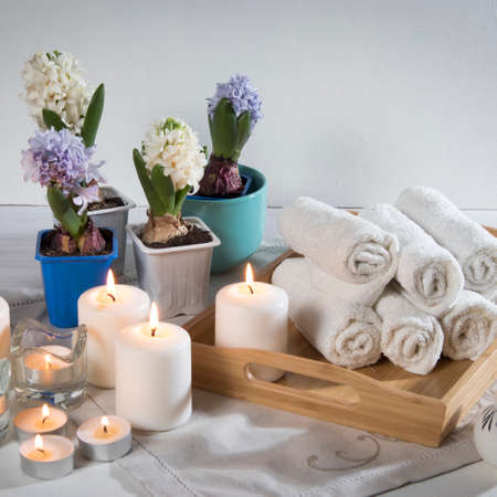 Tray with hand towels, hyacinths in pots in the bathroom of the spa salonの写真素材