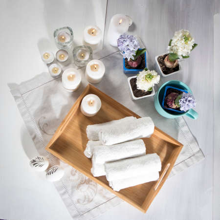 Tray with hand towels, hyacinths in pots in the bathroom of the spa salonの写真素材