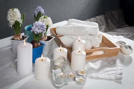 Tray with hand towels, hyacinths in pots in the bathroom of the spa salonの写真素材