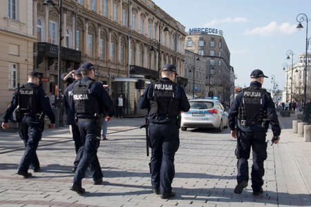 WARSAW, POLAND - April 08, 2018 XI Katyn March Shadow. In connection with the 78th anniversary of the Katyn Massacre. Police on the streets of Warsaw guard people during the marchのeditorial素材