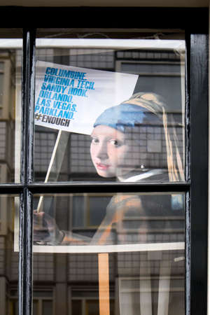 Amsterdam, Holland - 14 April 20018 the placard of Vermeer The girl with a pearl earring with protest agains shooting in USAのeditorial素材