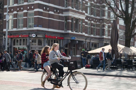 Amsterdam, Holland - 14 April 2018 view of bicyclist on Amsterdam street, Netherlandのeditorial素材