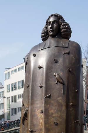 Amsterdam, Holland - 14 April 2018 Statue of Spinoza in Amsterdam against blue skyのeditorial素材