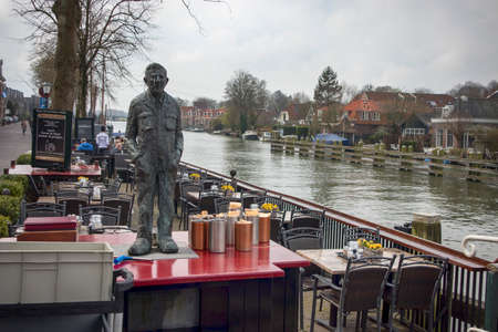 Muiden , Holland - 14 April 2018 Old building in small village Muiden. A man in the bas-relief at homeのeditorial素材