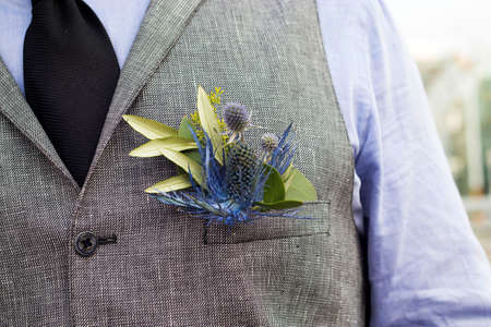 the Boutonniere in the pocket of the suits of the groom of eucalyptus and Eryngium