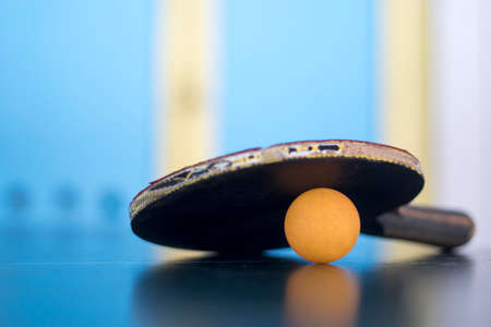 details of pingpong table with playing equipment and yellow ball.の写真素材