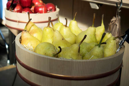LONDON, UK- SEPTEMBER 14 2018: Pears and apples in wicker baskets on store display for saleのeditorial素材