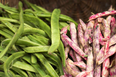 the two kinds of green and pink beans in a basket for sale at Borough Market