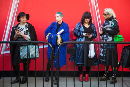 LONDON - FEBRUARY 15, 2019: Stylish attendees gathering outside 180 The Strand for London Fashion Week. Girls in line for fashion showsのeditorial素材