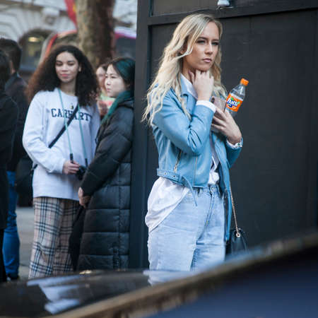 LONDON - FEBRUARY 15, 2019: Stylish attendees gathering outside 180 The Strand for London Fashion...