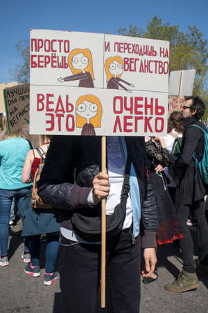 Moscow, RUSSIA - MAY 1, 2019: Moscow's Labor Day Parade. The girl holds a poster that says: just...