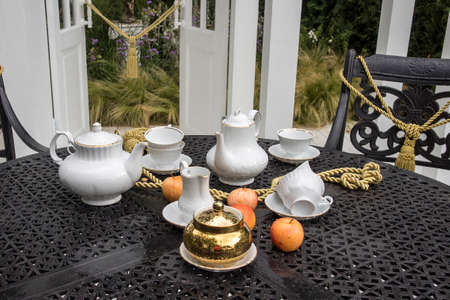 Tea set on the table in the garden. Landscape Designの写真素材