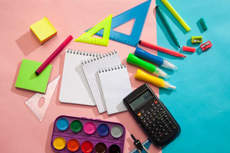 Preparation and learning of primary school children. Bright and multicolored school background with stationery accessories for the study of general subjects. Flat Lay, Copy space, place for text.の写真素材