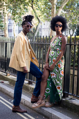 LONDON, ENGLAND - September 15, 2019 Stylish attendees gathering outside 180 Strand for London Fashion Week. Young man with dreadlocks in a yellow jacketのeditorial素材