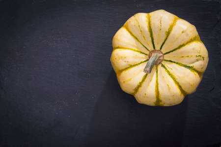 Pumpkins on the black stone board ready to cook and taste with the ingredients of your choice.の写真素材