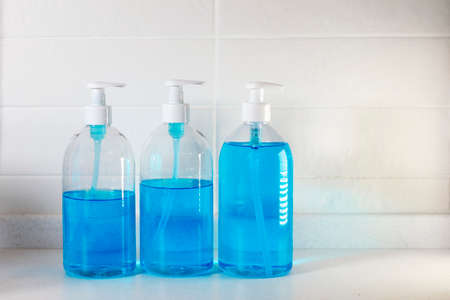 Copy space. Fragment of the interior of the kitchen. Liquid blue soap in a transparent plastic.