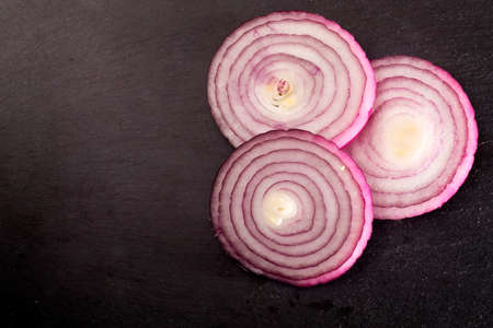 the red onion vegetable on the black background